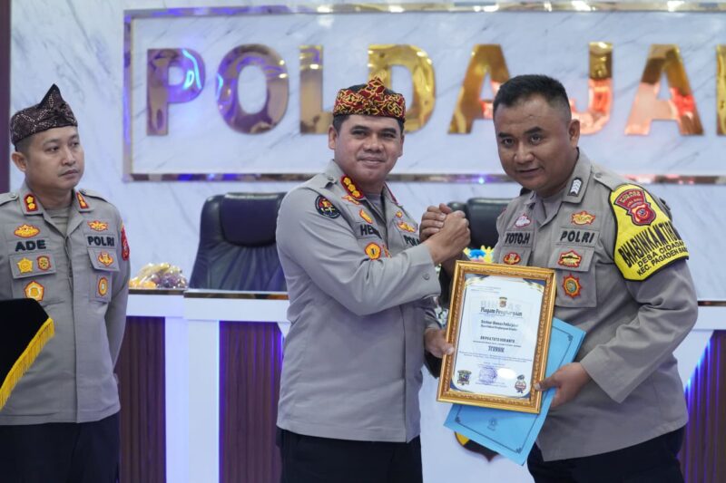 Kombes Pol. Hendra Rochmawan, Plt. Direktur Pembinaan Masyarakat Polda Jabar, menyerahkan penghargaan kepada Bripka Toto.